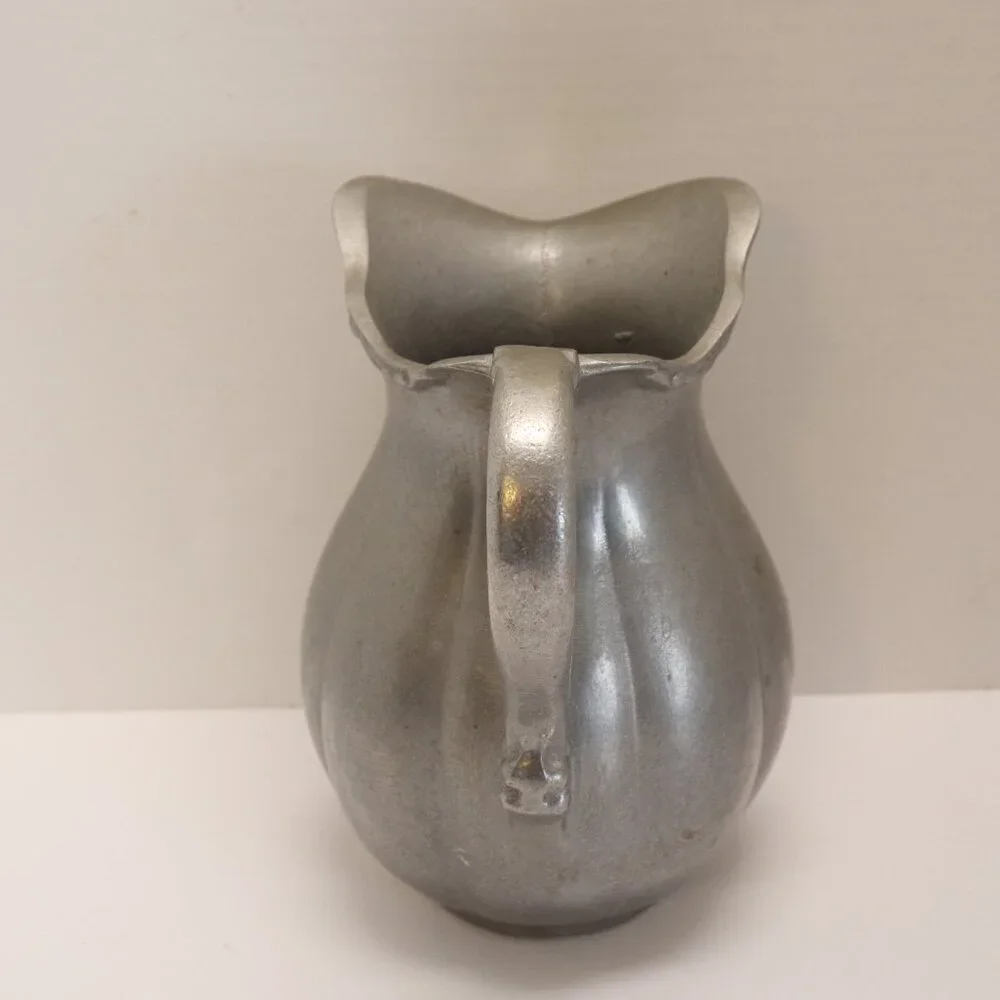 A Heavy Pewter Water Pitcher Pre Owner with some signs of wear